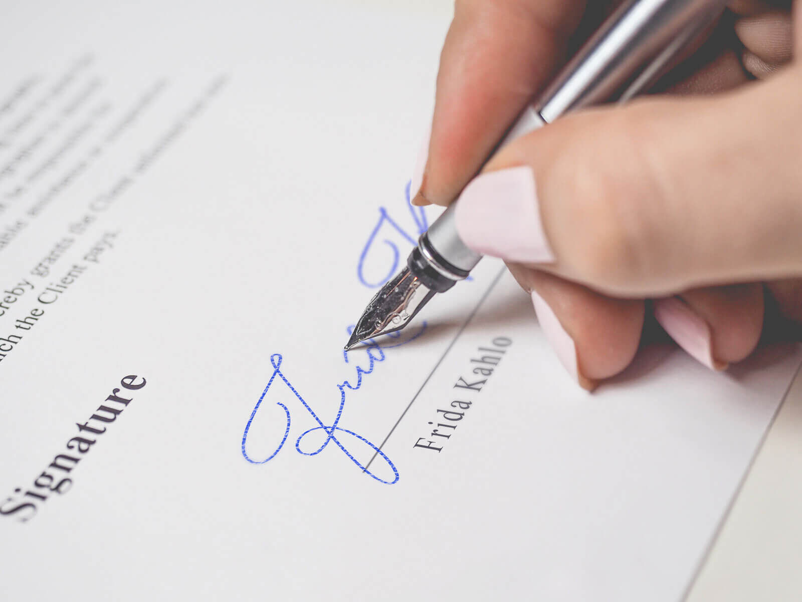 signature-mockup-of-a-female-hand-holding-a-fountain-pen
